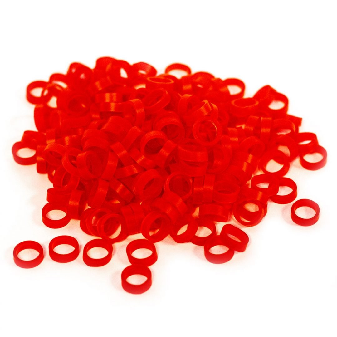Loose red Band of REBELS elastic silicone bands on white background.