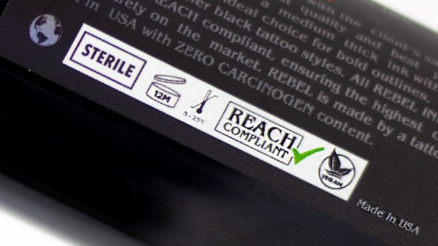 REBEL Black Tattoo Ink label close-up showing REACH and Vegan symbols for The Rebellion Reads.