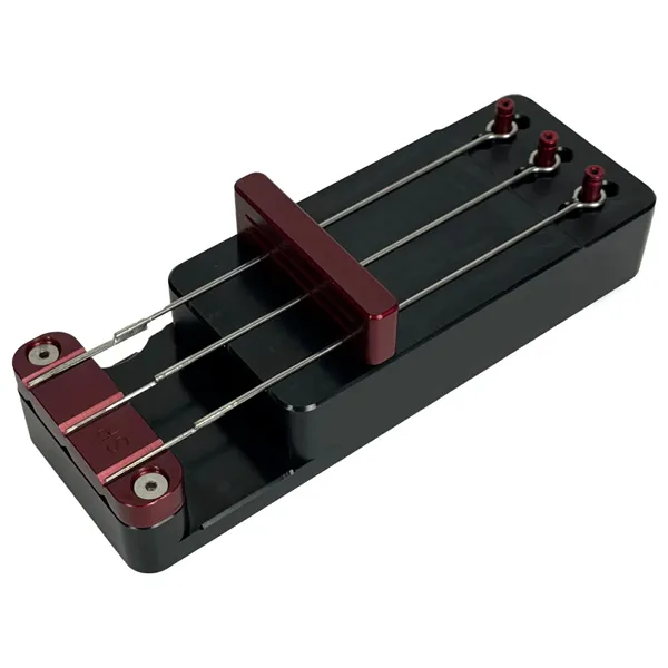 Needle bar jig used to solder tattoo needles onto traditional bars manually during manufacturing