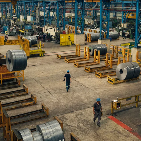 Large steel factory interior showing giant stainless steel rolls used before tattoo needle manufacturing