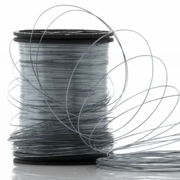 Smaller gauge stainless steel wire on a spool prepared for precision tattoo needle manufacturing