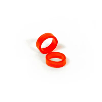 Two red Band of REBELS elastic silicone bands on white background, close-up view.