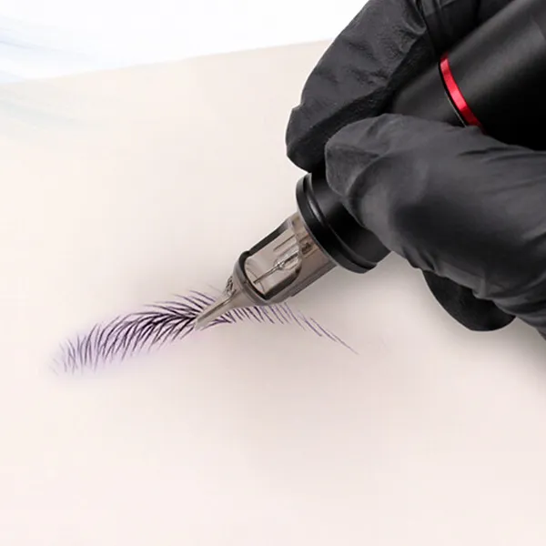 Tattoo artist practicing with cartridge on synthetic skin