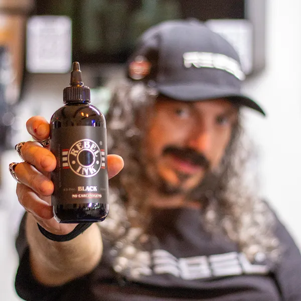 Caesar The Hun presenting REBEL REACH compliant tattoo ink as featured in Inked Magazine.