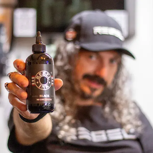 Caesar The Hun presenting REBEL REACH compliant tattoo ink as featured in Inked Magazine.