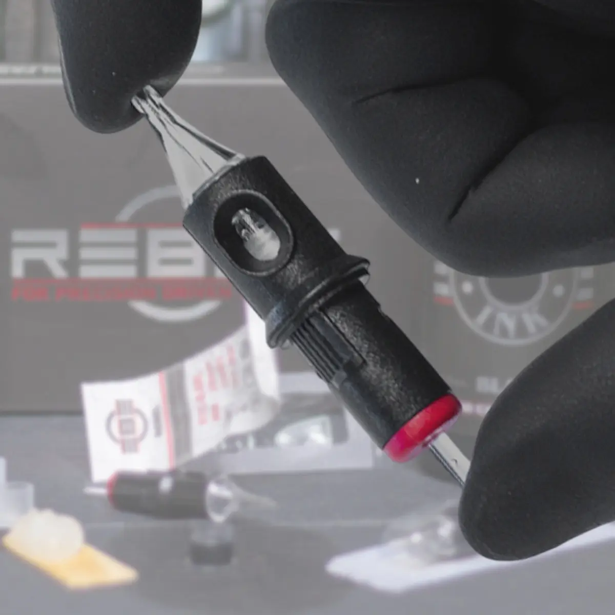 REBEL Precision round liner tattoo cartridge close-up showing the cartridge shape and size