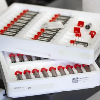 REBEL tattoo machine motors arranged in trays during R&D prototype development