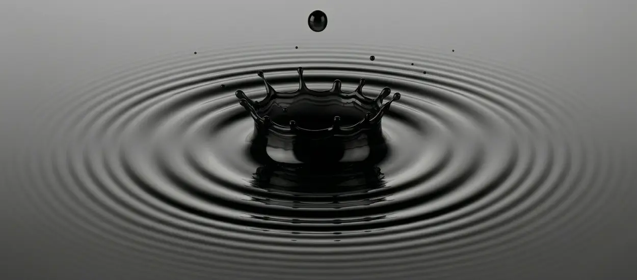 Black ink ripple symbolizing control, precision, and consistency in tattoo supply manufacturing