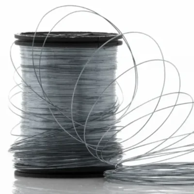 Fine gauge stainless steel wire spool after multi-stage drawing — the precise diameter wire cut into rods for tattoo needle production
