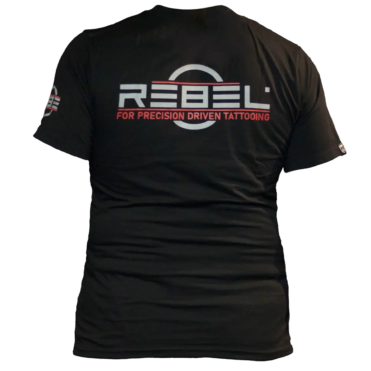 REBEL Precision Tee back view, REBEL logo and FOR PRECISION DRIVEN TATTOOING slogan, sleeve logo visible