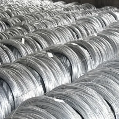 Large rolls of stainless steel wire stored in factory before being drawn down for tattoo needle manufacturing