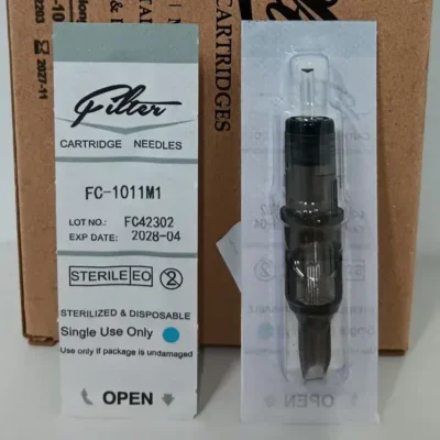 Tattoo cartridge blister pack showing front label with lot number and expiry date alongside sealed sterile cartridge back