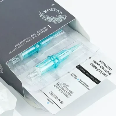 Open box of EO sterilized tattoo cartridges in individual blister packs with lot number and expiry date label visible