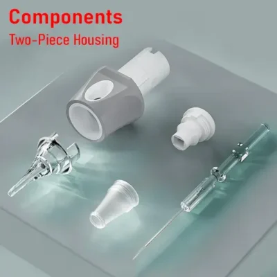 Tattoo cartridge components exploded view with two-piece gray housing, clear tip, membrane cap, and plunger assembly