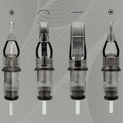Four tattoo cartridges showing needle type variations: round liner, round shader, regular magnum, and curved magnum with translucent gray housings and clear tips