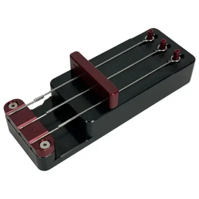 Tattoo needle bar soldering jig holding needle configurations in precise alignment — used in traditional needle-on-bar assembly before sterilization and packaging
