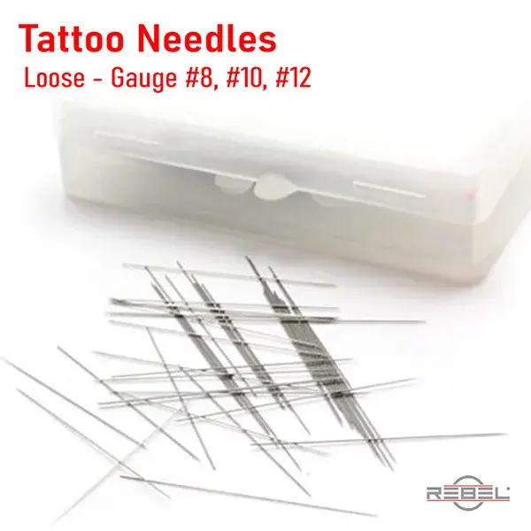 Loose tattoo needles in gauge #8, #10, and #12 next to storage case by REBEL