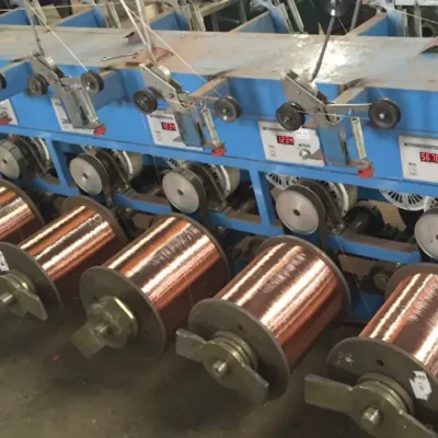 Industrial wire drawing machine with spools reducing steel wire diameter through multi-stage gauge reduction for tattoo needle manufacturing