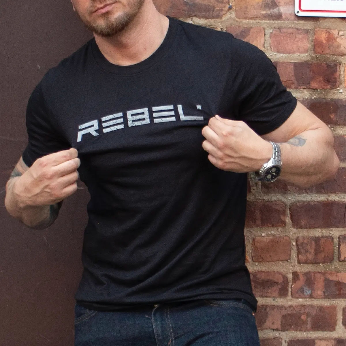 REBEL Grunge T-Shirt back view on tattooed model showing gray grunge style word: REBEL