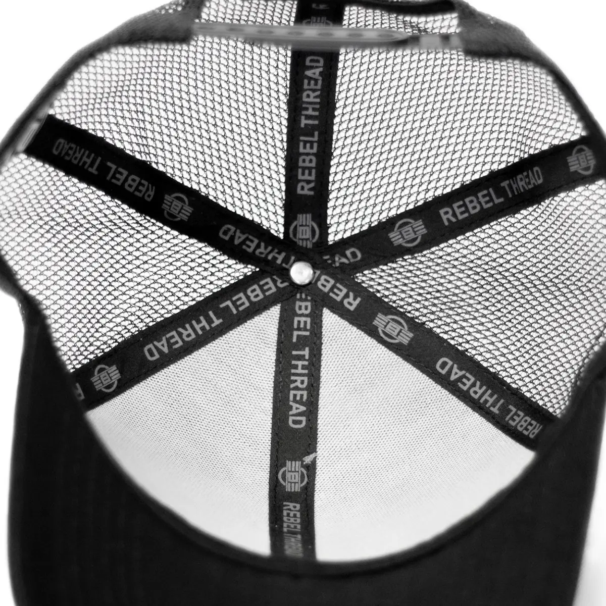 Interior view of REBEL Phantom Trucker Hat showing REBEL THREAD printed inner tape running across all panel seams