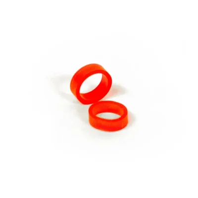 Two loose red silicone Band of REBELS tattoo cartridge ID bands